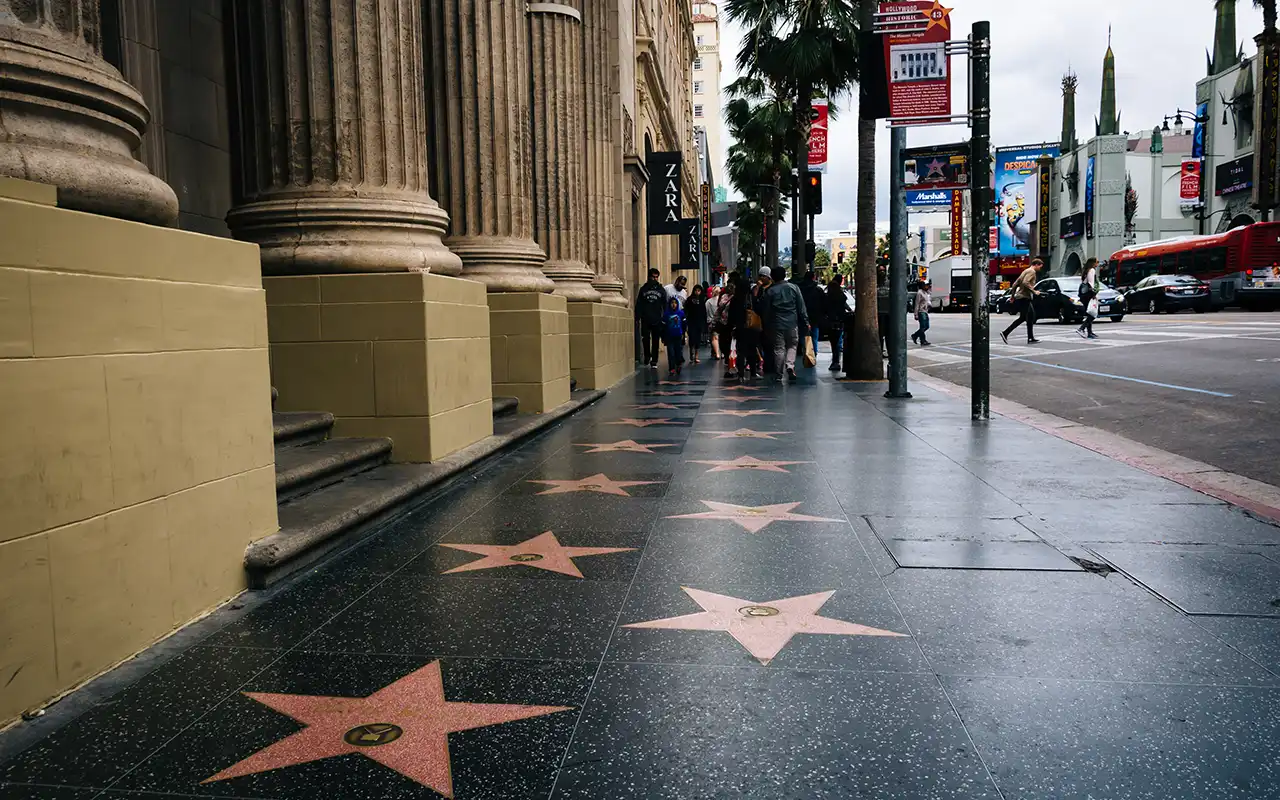 Group of tourists admiring the stars on the Hollywood Walk of Fame