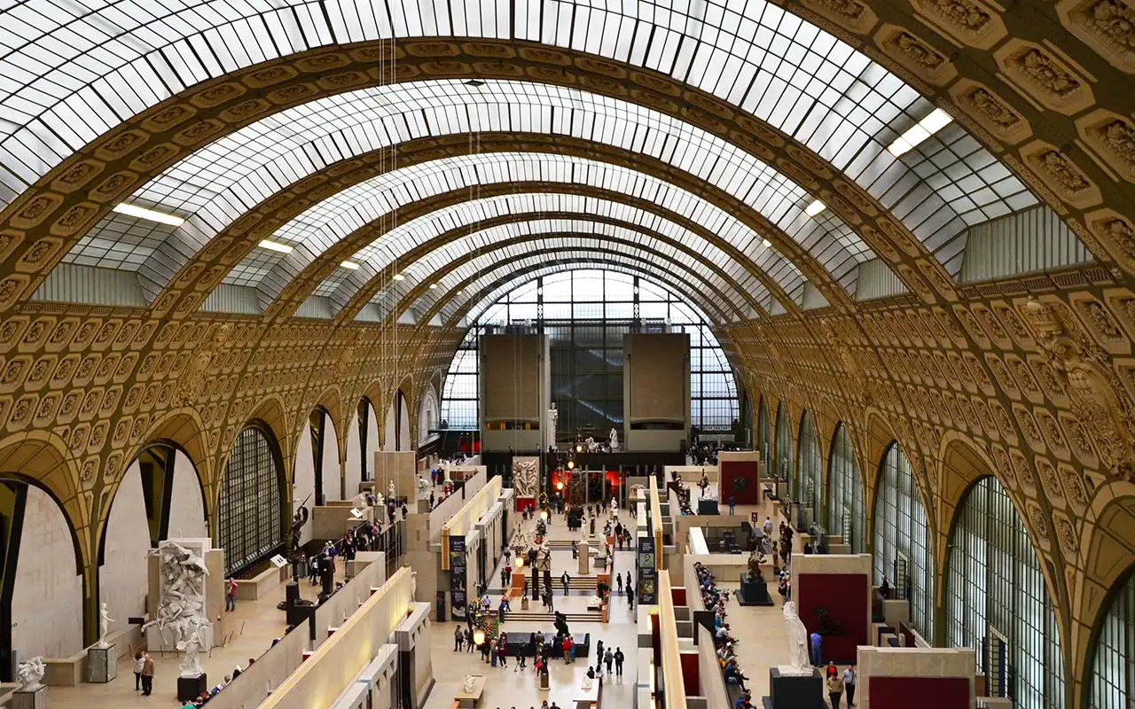 Inside the Musee d'Orsay, a stunning art museum housed in a historic train station in Paris, showcasing Impressionist and Post-Impressionist masterpieces.