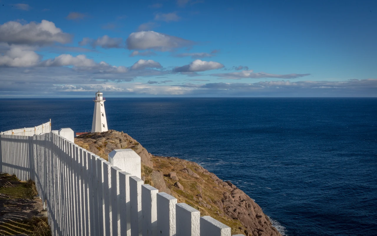 Cape Spear lighthouse standing majestically on the rocky coastline of Newfoundland, Canada