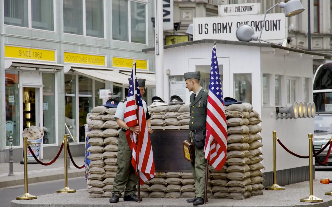 Soldiers at Checkpoint Charlie in Berlin with American flags