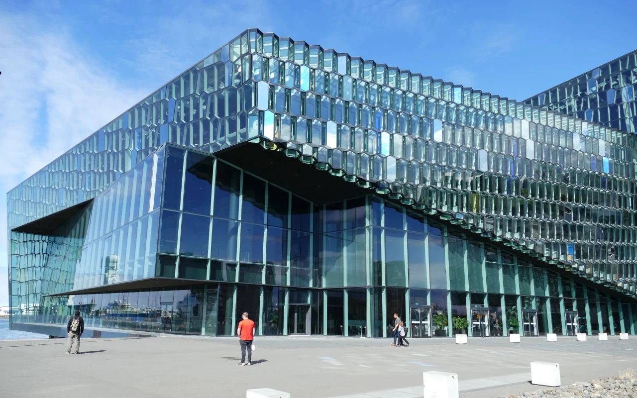 Stunning Harpa Concert Hall illuminated at night, showcasing its modern glass architecture and vibrant atmosphere
