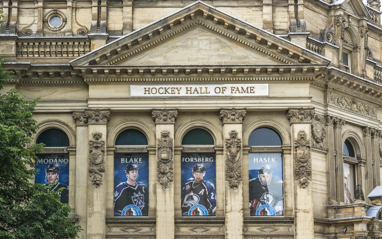 Hockey Hall of Fame entrance with famous players' statues and museum exhibits in the background