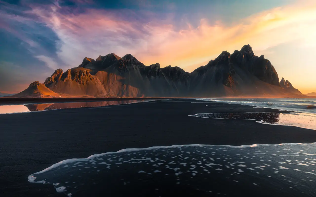 Scenic view of mountains and beach in Iceland at sunset