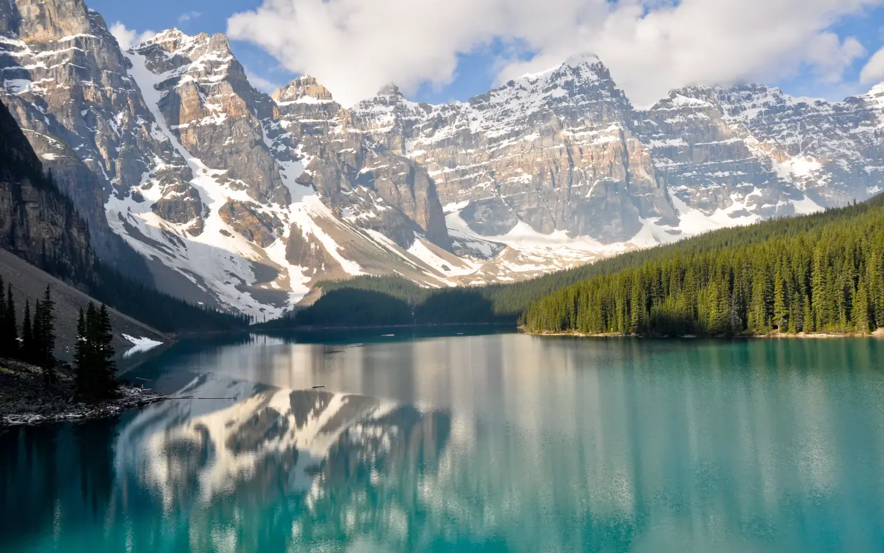 Moraine Lake reflecting towering mountains and lush forests