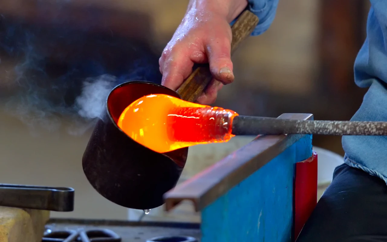 Artisan demonstrating the traditional Murano glass blowing technique in Italy