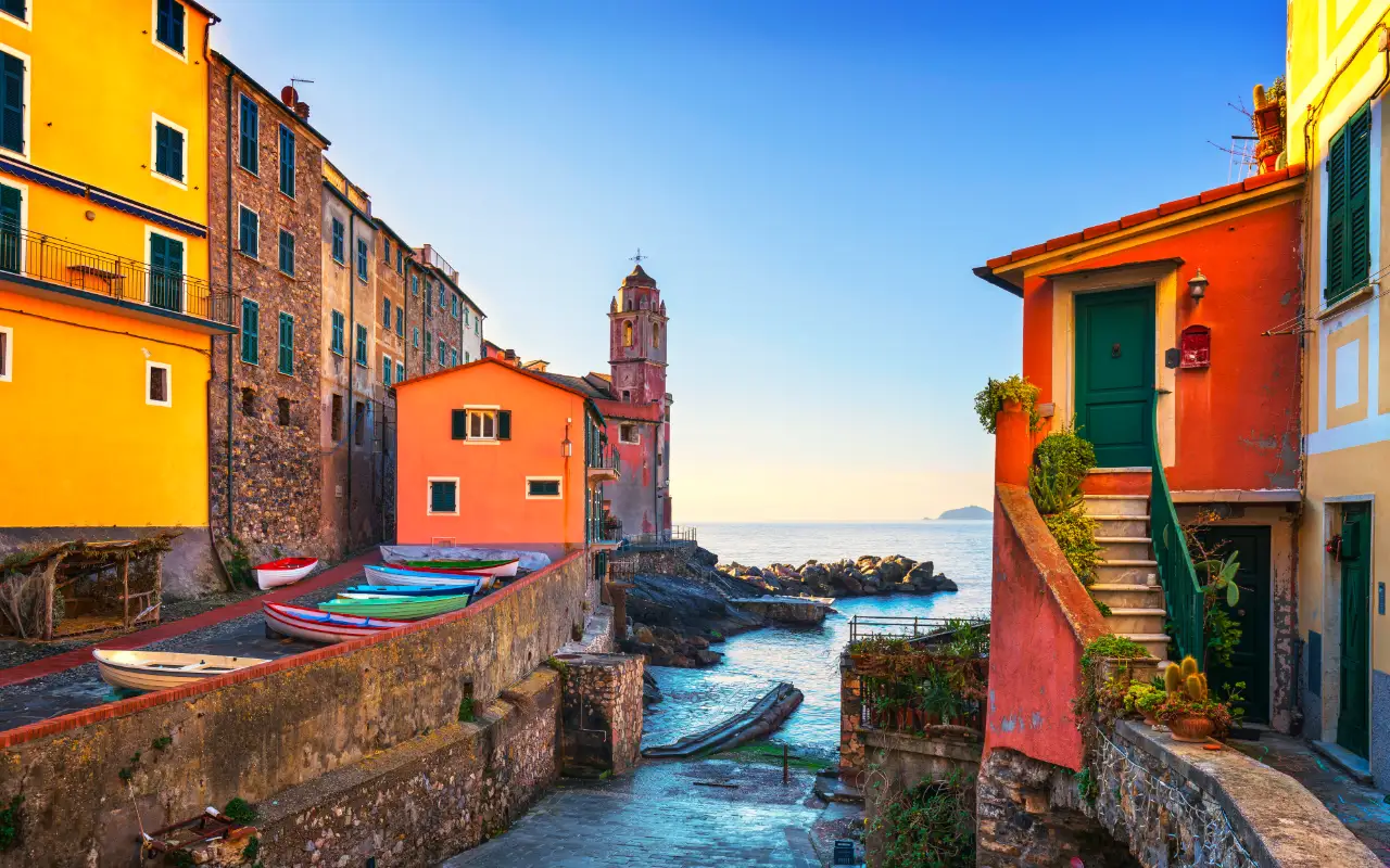 Colorful houses and boats in the coastal village of Tellaro, Italy at sunrise with a view of the sea
