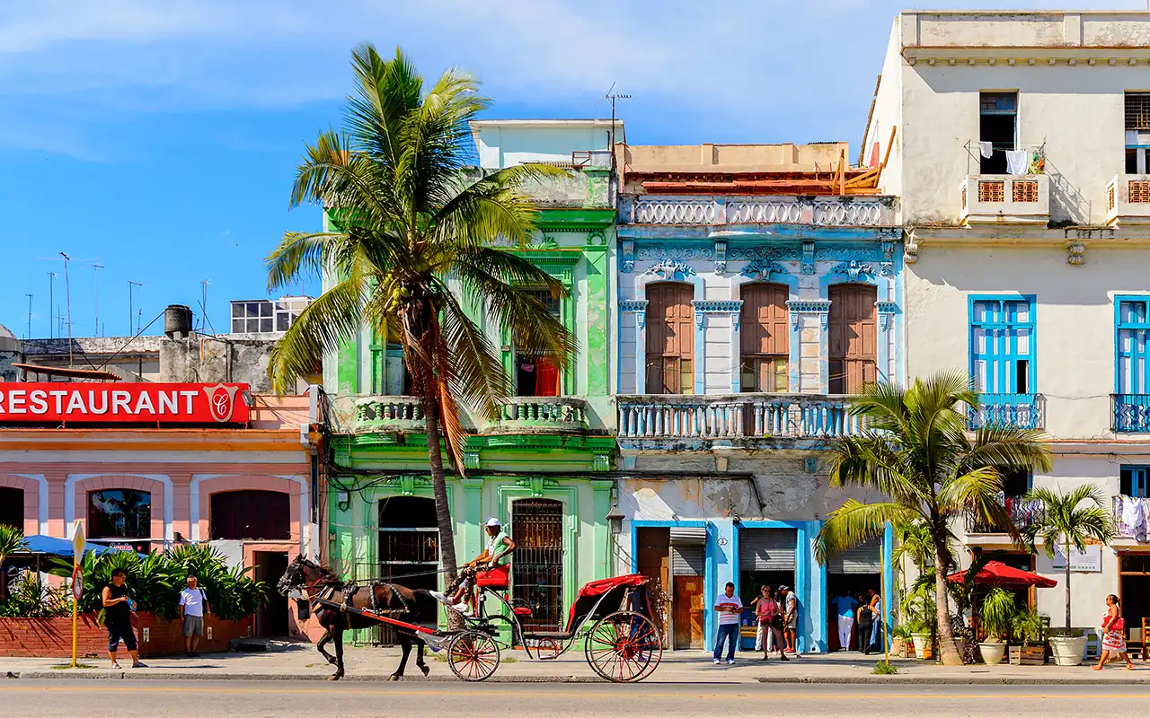 Colorful street scene displaying cultural activities representing things to do in Cuba