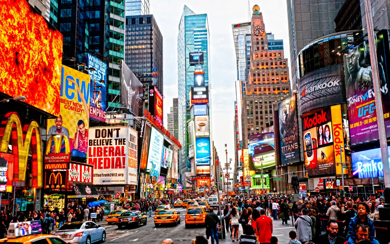 Bustling Times Square in New York City with bright neon billboards and crowds of people