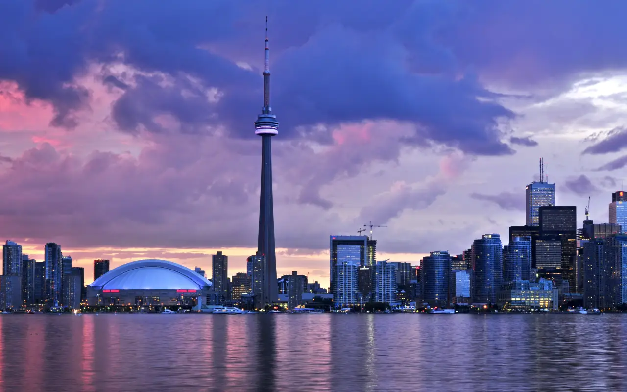 Toronto skyline with CN Tower and waterfront during sunset