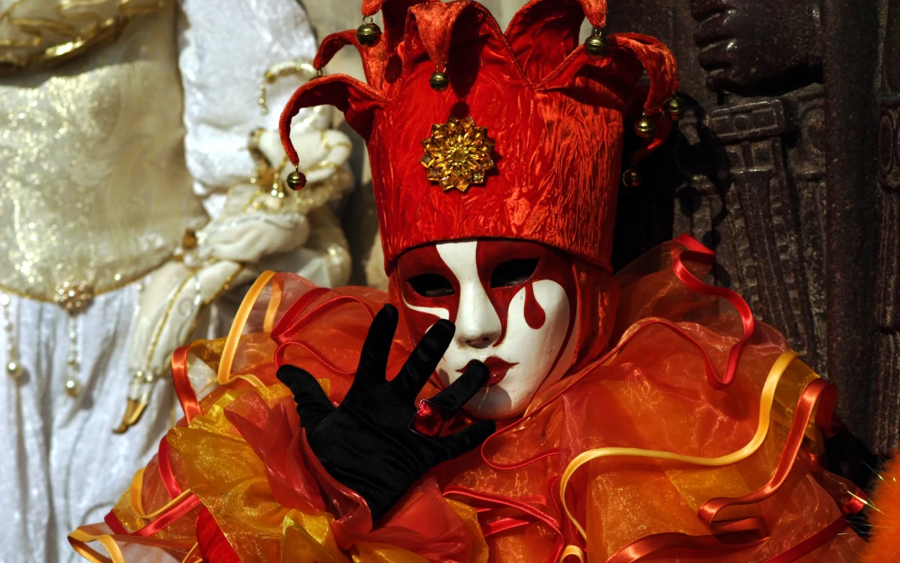 Orange jester entertaining crowd at the Venice Carnival