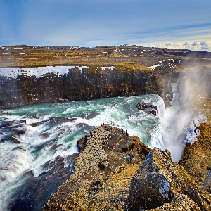 Stunning Gullfoss waterfalls in Iceland with cascading water and lush green landscape