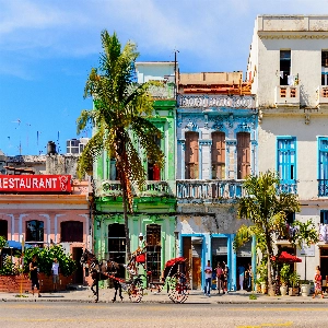 Colorful street scene displaying cultural activities representing things to do in Cuba