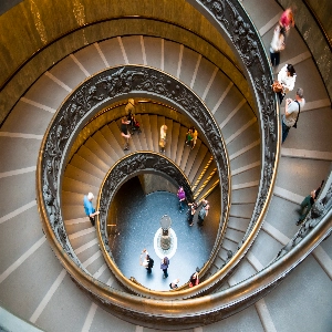 Interior view of the Vatican Museums featuring various historical artifacts and paintings