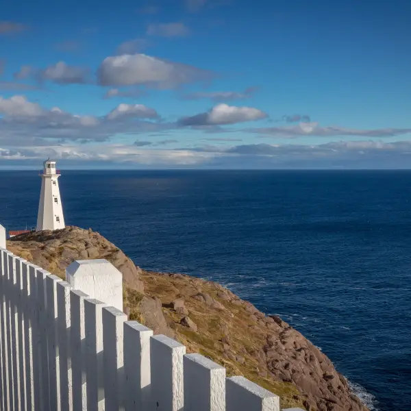 Cape Spear lighthouse standing majestically on the rocky coastline of Newfoundland, Canada