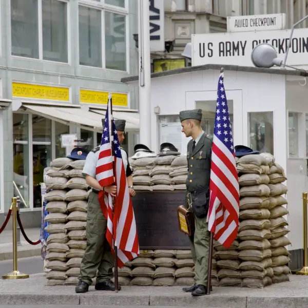 Soldiers at Checkpoint Charlie in Berlin with American flags
