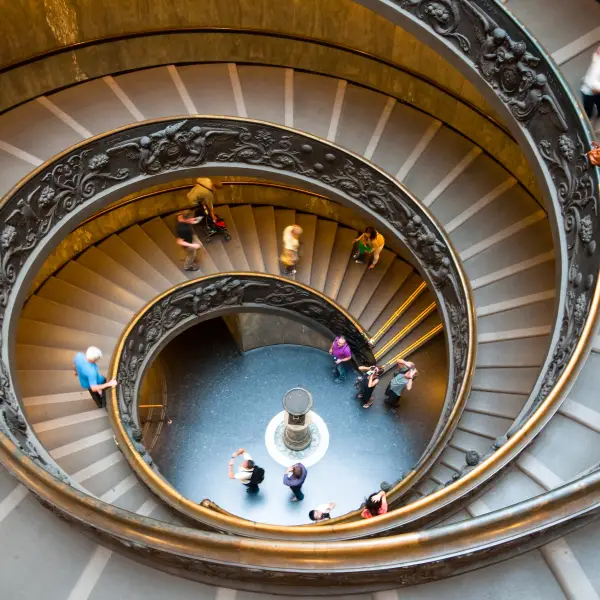 Interior view of the Vatican Museums featuring various historical artifacts and paintings