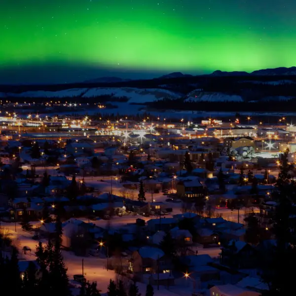 whitehorse-yukon-northern-lights-over-snowy-cityscape
